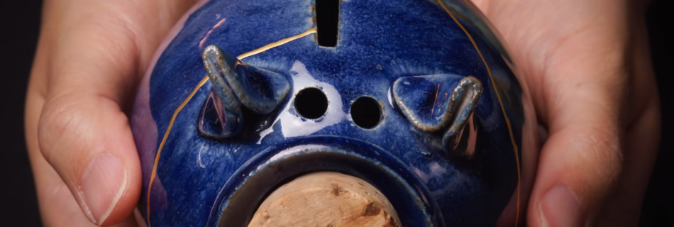kintsugi repaired piggy bank in hands